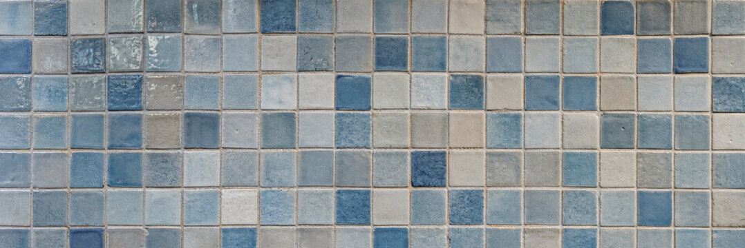Vintage blue mosaic tile texture, weathered ceramic square tiles background, rustic stone wall surface for bathroom or pool design