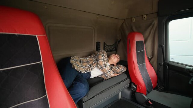 Tired female truck driver sleeping in cabin berth