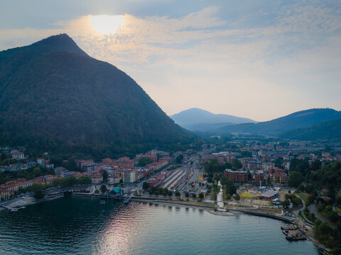 Aerial drone view of Laveno-Mombello town on the shores of Lake Maggiore in Italy, with picturesque lakeside scenery and Alpine mountains