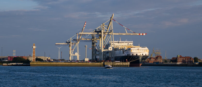 HAMBURG, GERMANY - AUGUST 26, 2026 - Large cargo ship moored at a container terminal in the busy port of Hamburg