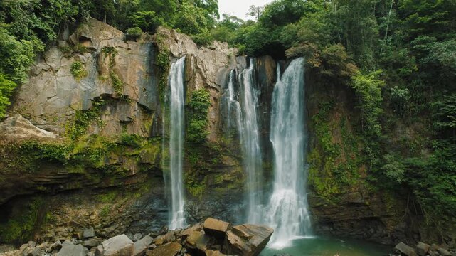 Nauyaca waterfalls cascading over rocky cliffs in rainforest of Costa Rica