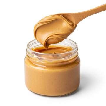 Creamy Peanut Butter in Glass Jar with Wooden Spoon.