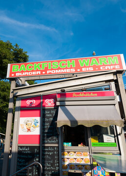 HAMBURG, GERMANY - AUGUST 26, 2026 - Hamburg street food stall selling Backfisch and Fischbrotchen under a blue sky