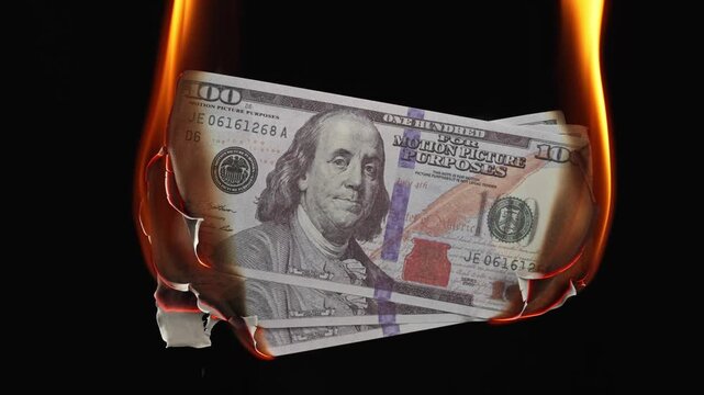 Burning dollar banknotes in fire on black background