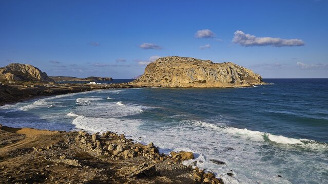 Rocky coastal landscape with blue sky and crashing waves, Acropolis Hill, Arkasa, West Coast, Karpathos, Dodecanese, Greek Islands, Greece