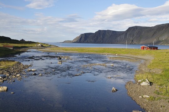 Green land with barren, stony mountains and a stream, single cabins, Gamvik, Arctic, Finnmark, Norway