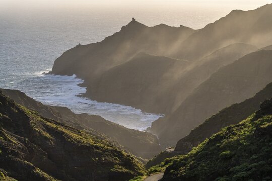 View of Punta San Lorenzo and Punta Sabina. The Playa de La Caleta is somewhat obscured. In the morning, good weather, mist rising in the valleys. La Gomera, Canary Islands, Spain