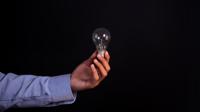 Creative Business Idea and Innovation Concept &ndash; Person Holding a Light Bulb Representing New Ideas, Inspiration and Problem Solving