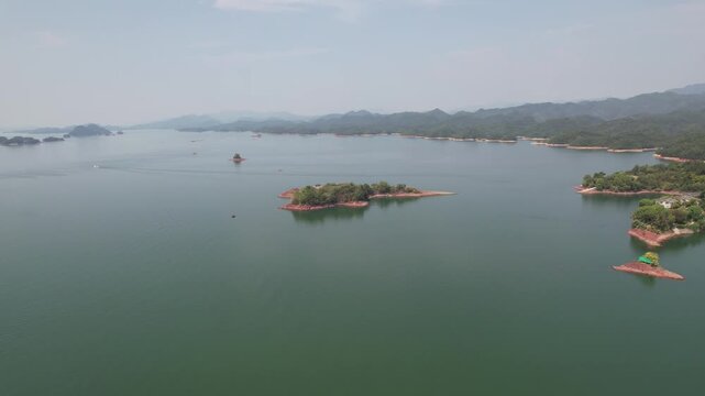 Forested islands surrounded by blue water in Qiandao Lake China