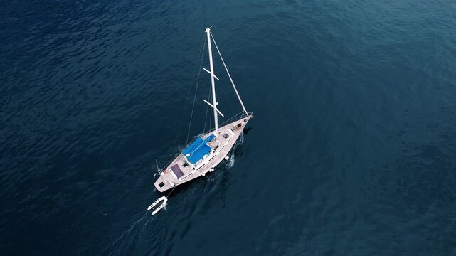 Quiet boat drifting on water. Tranquil maritime scene featuring solitary captain navigating calm open sea