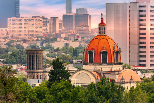 Aerial view of the historic massive dome church The Sabatina against Mexico City skyline at dusk