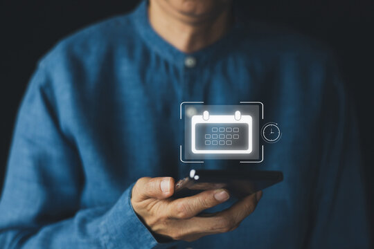 Business professional using smartphone with digital calendar interface for online scheduling, appointment management, time planning, mobile productivity, remote work, and smart business organization.