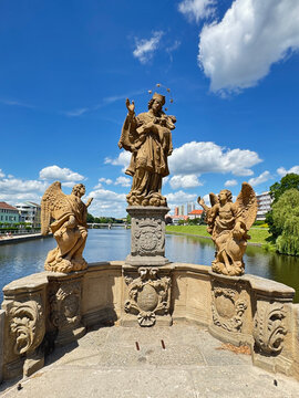 Statue of St John of Nepomuk at the oldest stone bridge in Pisek, Czechia