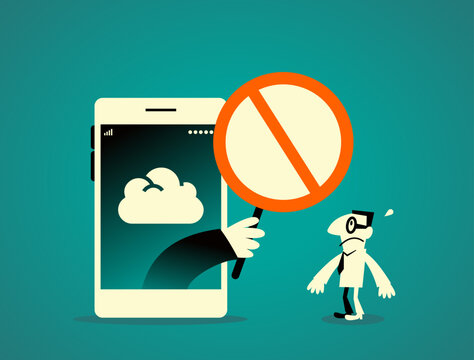 A hand reaching out from a smartphone screen holding a prohibited stop sign to block a businessman. For technology restrictions, internet privacy, data access denial, and cyber security concepts.