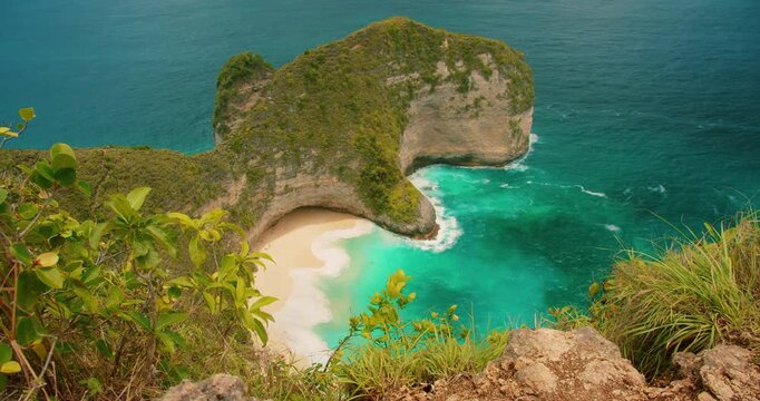 Steep green cliffs meet the turquoise Indian Ocean at Kelingking Beach Nusa Penida Bali