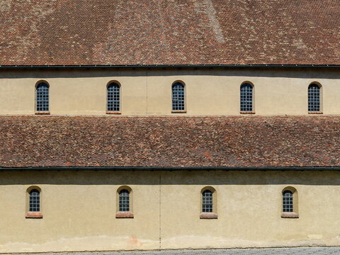 Historic Church Facade with Arched Windows and Terra Cotta Roof Tiles, Reichenau Abbey