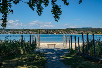 Fototapeta premium Peaceful Lake Constance Shore with Bench, Germany