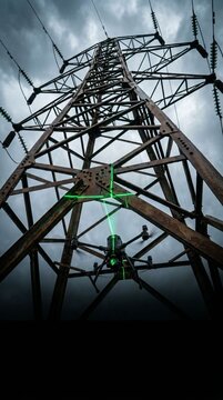 Low angle view of industrial drone scanning rusted electricity transmission pylon with green laser
