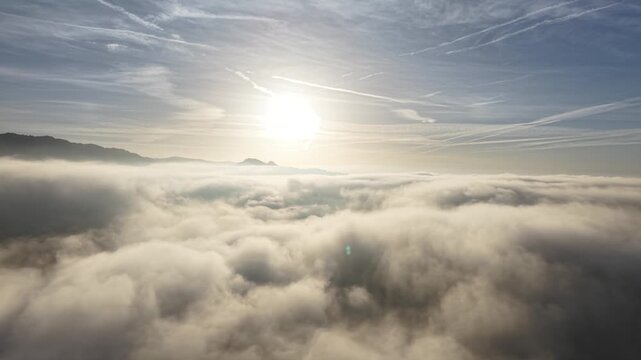 Drone footage with low level sun over the mist with small village. Shot on DJI Mavic Air 3s 4K 60fps 150mbit.
