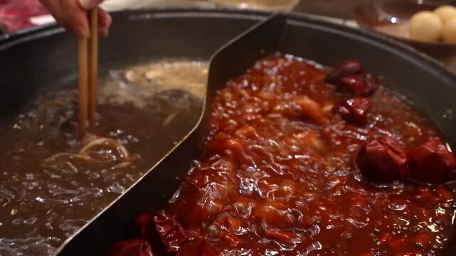 Red meat being cooked in mild and spicy Chinese Hot Pot in Chongqing China