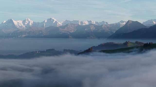 Eiger M&ouml;nch Jungfrau swiss alps over the mist at blue sky. Shot on DJI Mavic Air 3s 4K 60fps 150mbit.