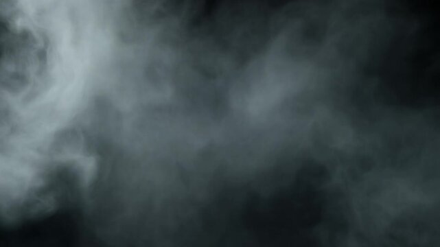 White smoke or fog flowing smoothly against a dark background
