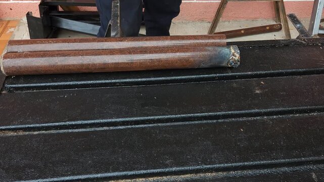 Marking Cut Line on Brown Painted Steel Tube Using Hacksaw Blade