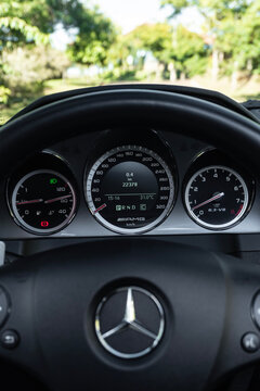 Driver POV View of Mercedes-Benz C63 AMG Dashboard and Steering Wheel Outdoors