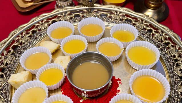 Traditional brass tray with fifty six yellow rice cakes with evoking cultural ritual ambiance paper
