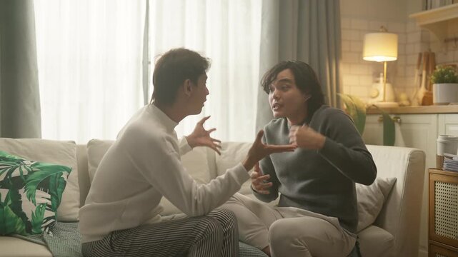 couple having intense heated argument on living room sofa, tense body language and raised voices, relationship conflict and emotional distress concept, dramatic indoor lighting.