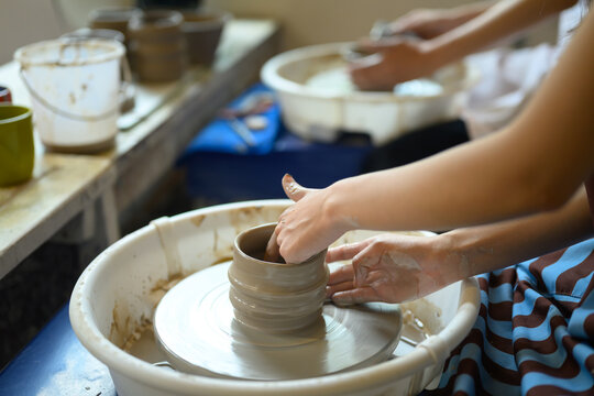 Ceramic Artist Shaping Clay Pot on Pottery Wheel in Creative Studio Workshop