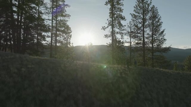 Wide Cinematic Drone Shot of Mountain Ridge and Distant Hikers