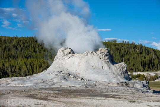 Steam escaping Castle Geyser in Old Faithful area of Upper Geyser Basin, summer vacation exploring Yellowstone National Park
