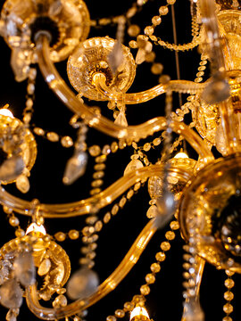 Elegant Gold Crystal Chandelier Close Up, Luxury Glass Light Fixture Detail Black Background