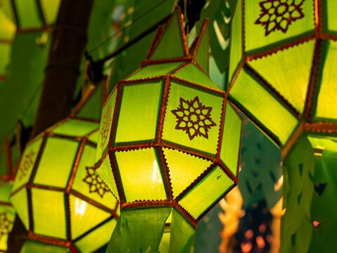 Glowing Green Paper Lantern with Floral Motif at Night, Warm Illuminated Decoration