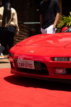 Front Close-Up of Red Honda NSX Sports Car on Red Carpet Display