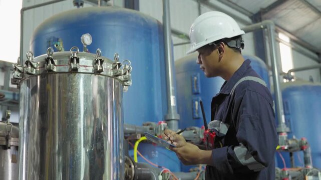 Electrical engineers are checking the maintenance systems of machinery in industrial plant. Professional engineering are taking note report data on equipment usage during work. Factory industry 