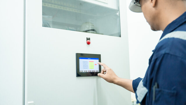 Environment Engineers checking data electrical control panels, air pollution reduction on digital displays.Technician management continuous emission monitoring system in factory and industry. ESG. ECO