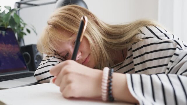Independent teenage girl study alone at home and writing notes at desk, building knowledge and academic skills through focused learning.Concept personal growth, responsibility and youth development