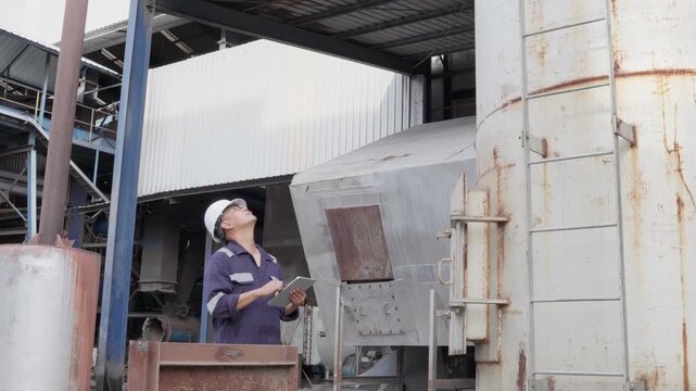 Engineering work using digital tablet maintenance Exhaust system concept Clean air environmental protection. Factory industrial manufacturing. Sustainable future environment air pollution reduction