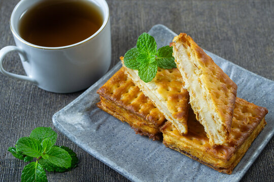 Indonesian sweet snack Gabin Tape, made of malkist crackers and sweet fermented cassava tape singkong. served on a grey square plate
