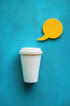 white disposable coffee cup with lid on turquoise textured wall and yellow speech bubble cutout, playful cheerful minimalist scene