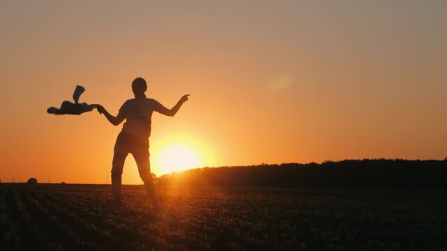 Farmer Dancing With Scarf in Full Silhouette at Sunset