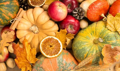 Pumpkins, apples, rye, nuts, and autumn leaves, close-up, top view. Harvest Festival celebration concept. © Ирина Гутыряк