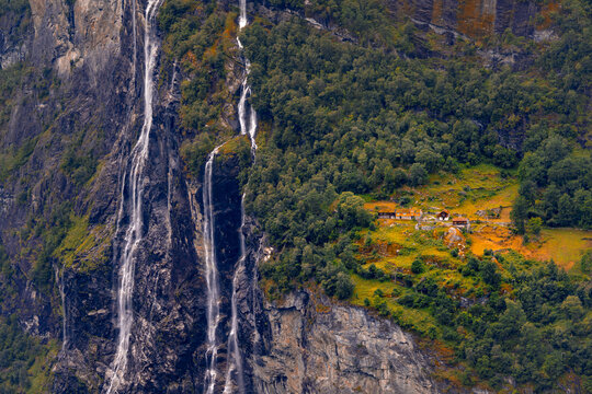 A beautiful waterfalls over the cliffs in the Geiranger village. A summer scenery of World Heritage area in Western Norway.