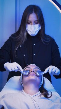 Esthetician performing cryotherapy facial massage with Ice Globes