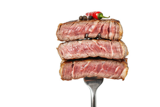 Three slices of grilled beef steak stacked on a metal fork with chili pepper and peppercorns isolated on a transparent background
