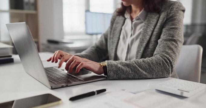 Woman hands typing laptop at office desk. Professional working on computer keyboard during business work tasks with paperwork and pen on table in workspace. Focus on efficiency and technology.