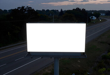 Fototapeta premium Advertising mockup, blank billboard on highway for outdoor marketing campaign and brand promotion at twilight with empty space for custom design