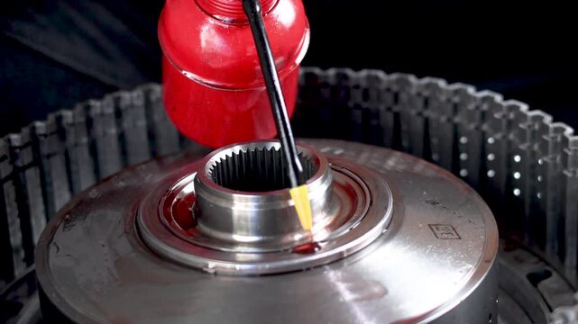 Lubricating transmission thrust bearing during gearbox assembly.